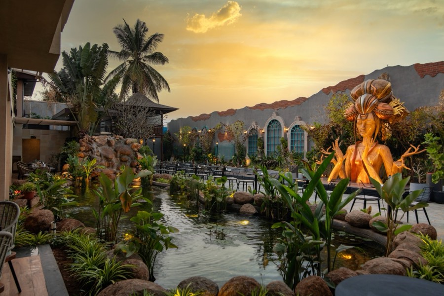 Golden light on the pond and goddess statue
